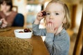 Cute little toddler boy eating grapes at home. Fresh organic frutis for infants Royalty Free Stock Photo