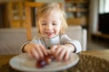 Cute little toddler boy eating grapes at home. Fresh organic frutis for infants Royalty Free Stock Photo