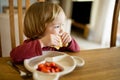 Cute little toddler boy eating pancakes and strawberries at home. Fresh organic frutis for infants Royalty Free Stock Photo