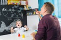 Cute little toddler boy at speechtherapist session.