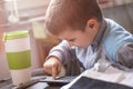 Cute little baby boy using a calculator Royalty Free Stock Photo