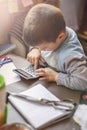 Cute little baby boy using a calculator Royalty Free Stock Photo