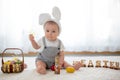 Cute little toddler child in sunny living room playing with Eas Royalty Free Stock Photo