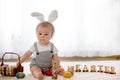 Cute little toddler child in sunny living room playing with Eas Royalty Free Stock Photo