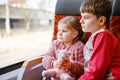 Cute little toddler girl and brother kid boy sitting in train and looking out of window. Two adorable happy healthy Royalty Free Stock Photo