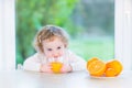 Cute little toddler girl drinking orange juice Royalty Free Stock Photo