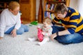 Cute little toddler girl, father and grandmother playing together. baby child, dad and and senior retired woman Royalty Free Stock Photo