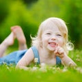 Cute little toddler girl laying in the grass Royalty Free Stock Photo