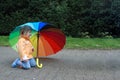 Toddler girl with  umbrella in rainbow colors Royalty Free Stock Photo