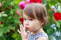 Cute little toddler girl picking her nose Royalty Free Stock Photo