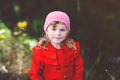 Cute little toddler girl in red coat making a walk through autumn forest. Happy healthy baby enjoying walking with Royalty Free Stock Photo