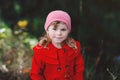 Cute little toddler girl in red coat making a walk through autumn forest. Happy healthy baby enjoying walking with Royalty Free Stock Photo