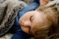 Cute little toddler girl sleeping in bed. Adorable baby child dreaming, healthy sleep of children by day. Royalty Free Stock Photo