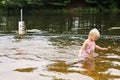Little Girl Child Swimming in Muddy Brown Lake Water on Summer Day Royalty Free Stock Photo