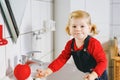 Cute little toddler girl washing hands with soap and water in bathroom. Adorable child learning cleaning body parts