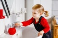 Cute little toddler girl washing hands with soap and water in bathroom. Adorable child learning cleaning body parts. Morning