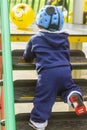 A cute little toddler is going after a yellow plastic ball Royalty Free Stock Photo