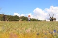 A cute little Ukrainian Caucasian girl in an embroidered shirt runs across the field. Royalty Free Stock Photo