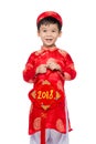 Cute little Vietnamese boy in red ao dai dress smiling. Tet Holiday. 2018 Royalty Free Stock Photo