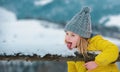 Cute little winter girl eating snow outdoor. Excited christmas kids holiday. Kids cold and flu concept. Kid lick snow