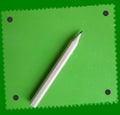 A cute little wooden pencil on a green block notes! Royalty Free Stock Photo