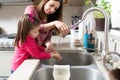 Little girl washing her hands at home