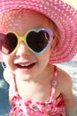 Happy Little Girl Laughing in Swimsuit, Sun Hat and Sunglasses Royalty Free Stock Photo