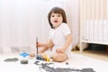 Cute little 2 years boy with brush and gouache paints at home Royalty Free Stock Photo