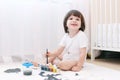 Cute little 2 years boy with brush and gouache Royalty Free Stock Photo