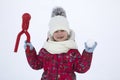 Cute little young funny toothless child girl in warm clothing pl Royalty Free Stock Photo