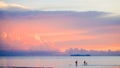 Cute lovely family walking on beach beautiful pastel sunset Royalty Free Stock Photo