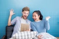 Cute loving couple is using tablet in sofa.