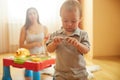 Cute loving curious baby boy playing toy indoor