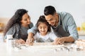 Cute loving family baking together, having flour on faces Royalty Free Stock Photo