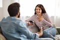 Cute loving indian couple using smartphone at home, have conversation Royalty Free Stock Photo