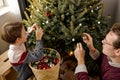 cute loving young caucasian father and little son have fun decorate Christmas tree together Royalty Free Stock Photo