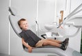 Adorable little boy sitting in dental chair. Royalty Free Stock Photo