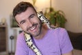 Cute man holding exotic ball python Royalty Free Stock Photo