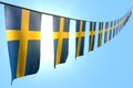 Beautiful labor day flag 3d illustration - many Sweden flags or banners hanging diagonal on rope on blue sky background with soft