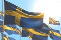 Wonderful feast flag 3d illustration - many Sweden flags are waving against blue sky image with bokeh