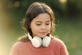 Cute melomane. Little girl child wearing headphones. Happy child enjoy listening to music on the go. Adorable little Royalty Free Stock Photo