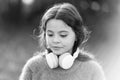 Cute melomane. Little girl child wearing headphones. Happy child enjoy listening to music on the go. Adorable little Royalty Free Stock Photo