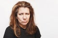 Cute middle-aged woman on gray background angry as her hair starts to become gray Royalty Free Stock Photo