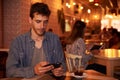 Cute millennial looking at his cellphone Royalty Free Stock Photo