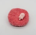 Cute Mini ice-cream bath bomb on red fluffy carpet Royalty Free Stock Photo