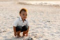 Cute mixed race baby boy with curly hair portrait. Charming curly kid playing on the beach of the estuary Royalty Free Stock Photo