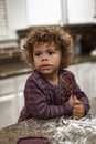 Cute Child helping in the kitchen and making a huge mess