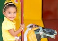 Cute mixed race girl riding a carousel Royalty Free Stock Photo