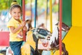 Cute mixed race girl riding a carousel Royalty Free Stock Photo