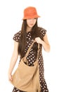 Cute mixed race teen girl holding her purse wearing an orange ha Royalty Free Stock Photo